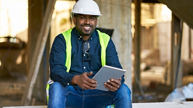 Construction worker sitting smiling