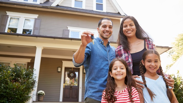 Family in front of their new home