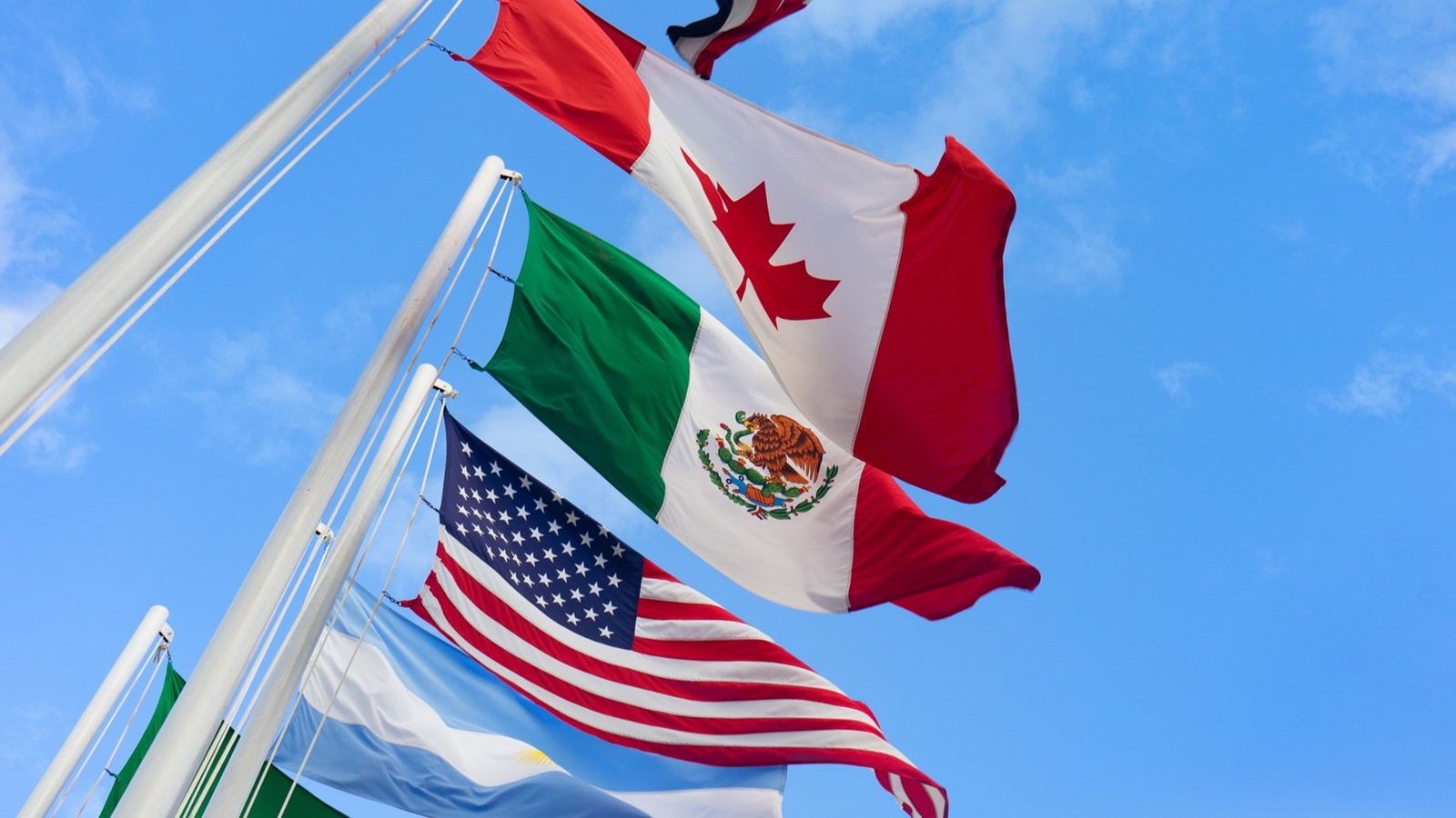 Flags of US, Canada, and Mexico representing tariffs